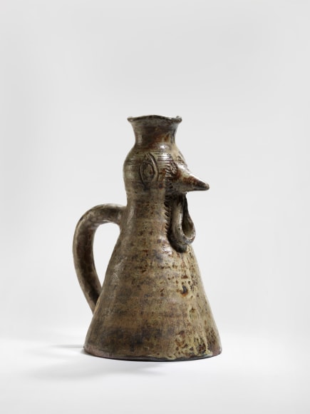 photograph of a zoomorphic hen jug in an empty room