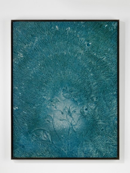 photograph of a turquoise artwork on a white wall