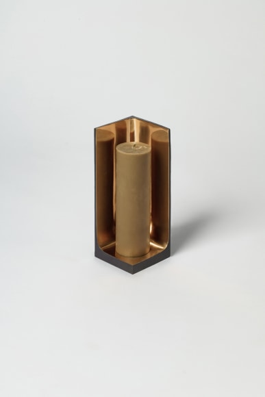 Bronze candlestick with gold detailing and black exterior.