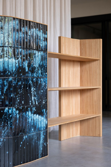 wooden bookshelf with blue panels in a room