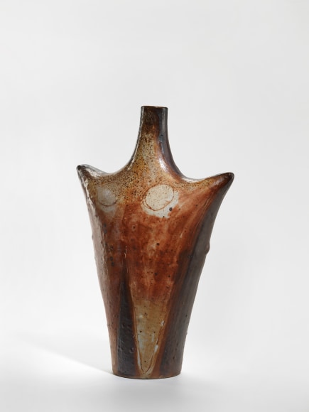 photograph of an anthropomorphic starfish vase in an empty room