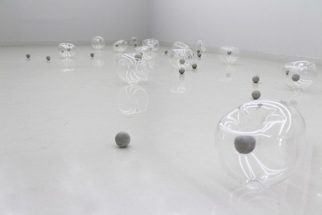 photograph of amorphous glass spheres and concrete balls