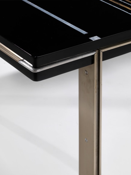 photograph of a black table in a blank room