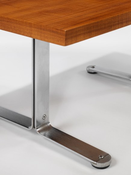 photograph in blank room with table by Tallon made with teak wood top and steel and metal legs