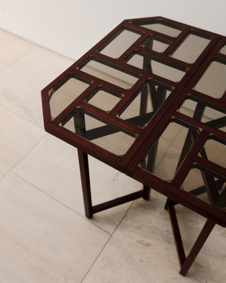 Detail shot of wooden and glass console table in a geometric pattern from base and top by Pierre Paulin.