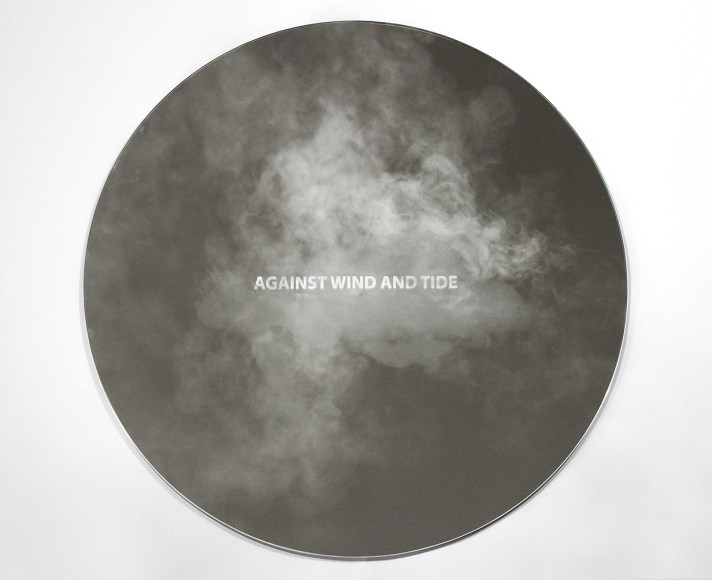 image of a mirror with fog treatment on it that says against wind and tide.
