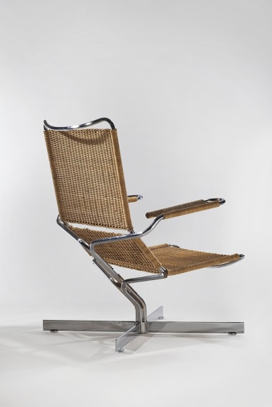 picture of rattan chair with steel legs in a blank room
