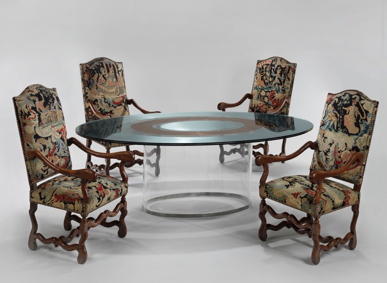 picture of a table with glass base in a gray room