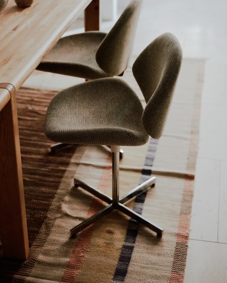Installation view of works in the gallery, mostly furniture and some rugs and art.
