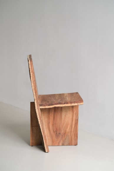 wood and cork chair with angled back shown in every angle against a grey background.
