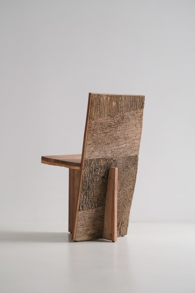 wood and cork chair with angled back shown in every angle against a grey background.