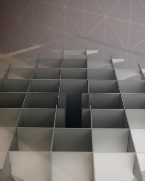 View of Paulin Cathedral Table in the gallery with glass top.