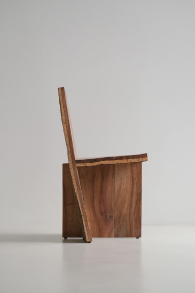 wood and cork chair with angled back shown in every angle against a grey background.