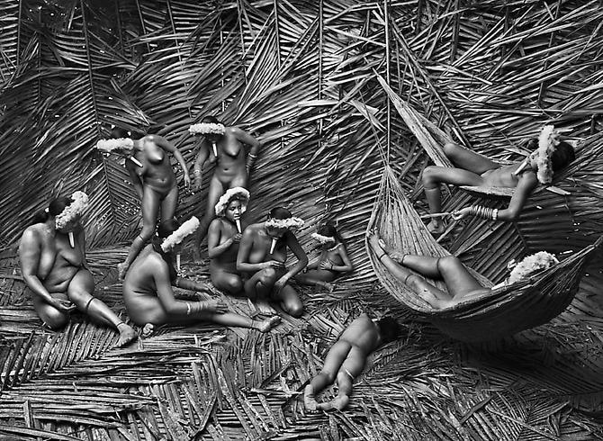 Women in the Zo’é village of Towari Ypy color their bodies with the red fruit of the urucum, Pará, Brazil, 2009, gelatin silver print, 61 x 89 cm (24 x 35 inches)
