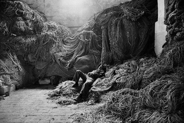 Sebasti&atilde;o Salgado, A tuna fisherman asleep on a net, Trapani, Sicily, Italy, 1991, gelatin silver print