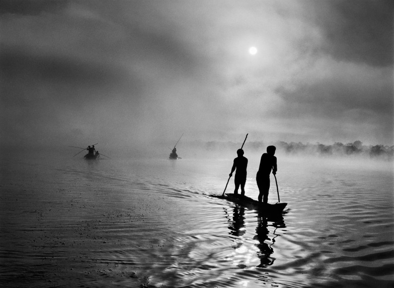Sebasti&atilde;o Salgado, At daybreak, Waur&aacute; Indians travel by canoe to collect the &ldquo;waiting net,&rdquo; Xingu Indigenous Territory, state of Mato Grosso, Brazil, 2005, gelatin silver print, 50.8 x 61 cm (20 x 24 inches)