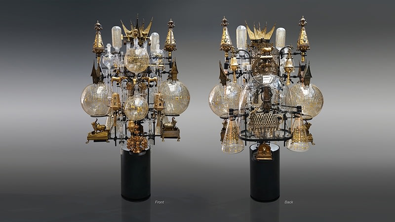 Ghiora Aharoni, The Immanent Transcendental, 2017–2020, assemblage sculpture with laboratory tubes, flasks and beakers (some etched with Hebrew text from Exodus and the Medieval scholar Rashi’s writings, in-filled with 23-karat gold); antique glass dome; antique Torah scroll finials; bronze, brass and metal icons with tubular lights and an illuminated steel base, 177.8 x 114.3 x 96.5 cm (70 x 45 x 38 inches)