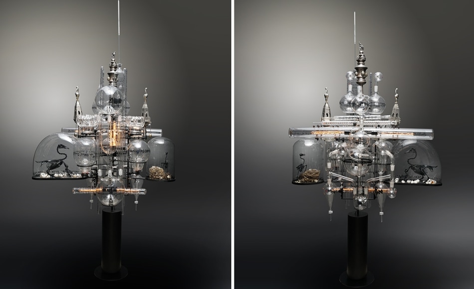The Genesis Series - Day II B, 2021, assemblage sculpture with glass beakers, tubes, flasks and domes with engraved, appliqu&eacute; and printed text; laboratory clamps; icons and iconography, tubular lights and steel base, 95 x 50 x 42 inches/241.3 x 127 x 106.7 cm
