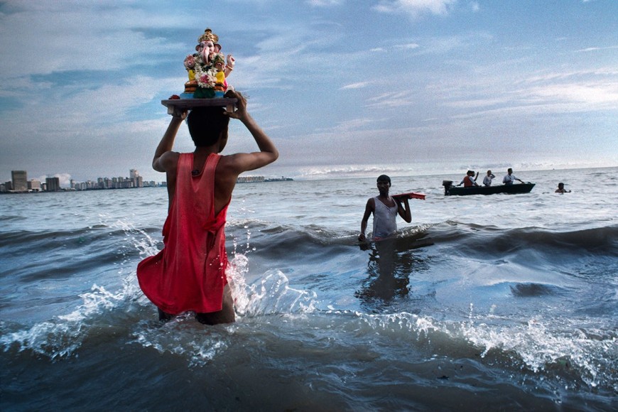 Steve McCurry, Devotee carries statue of Lord Ganesh into the waters of the Arabian Sea during the immersion ritual off Chowpatty beach, Mumbai, India, 1993, ultrachrome print, 101.6 x 152.4 cm (40 x 60 inches)