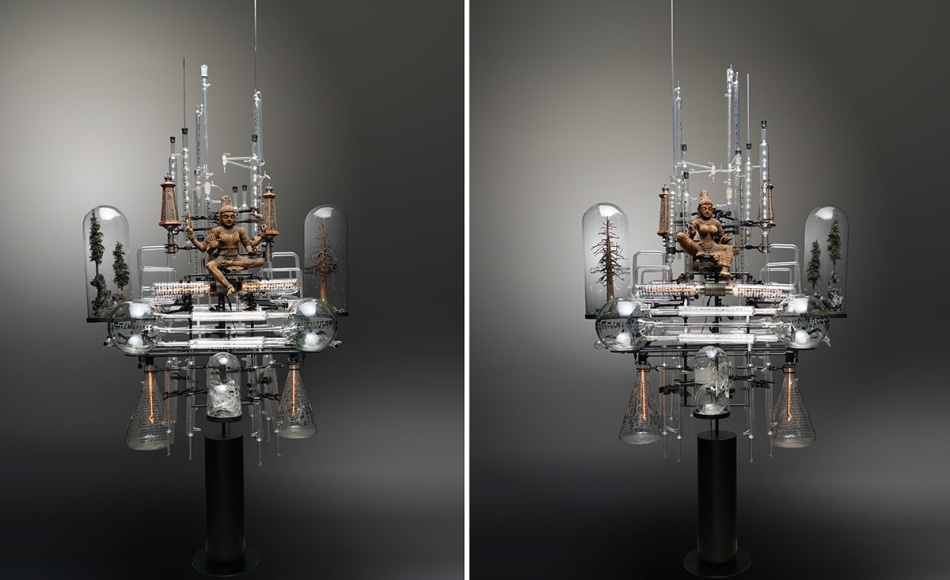The Genesis Series - Day I B, 2021, assemblage sculpture with glass beakers, tubes, flasks and domes with engraved, appliqu&eacute; and printed text; laboratory clamps; icons and iconography, tubular lights and steel base, 103 x 50 x 34 inches/261.6 x 127 x 86.4 cm