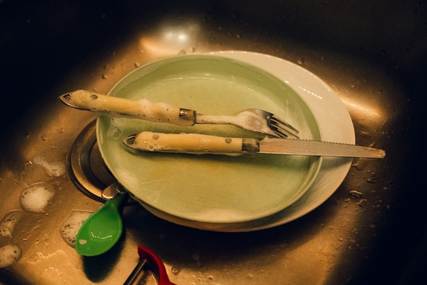 Maria Abranches, A pile of washed dishes from one of the families Ana Maria Jeremias works for, who have small children, in the Estrela neighborhood. Lisbon, Portugal.