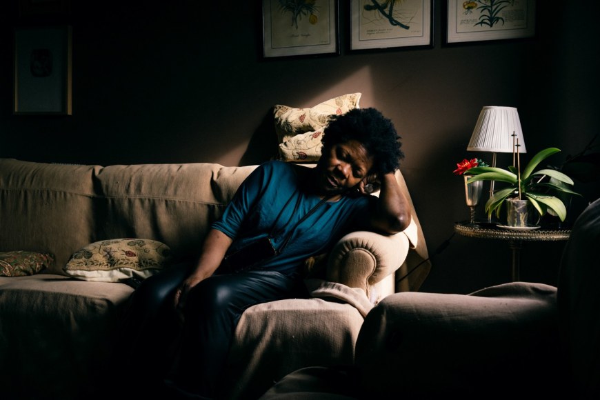 Maria Abranches, Ana Maria Jeremias, exhausted, sitting on her employer's couch after lifting the elderly woman up when she fell to the floor in the Estrela neighborhood. Lisbon, Portugal.