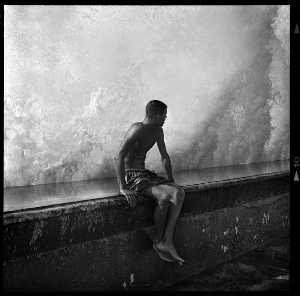 Seated Boy on Malec&oacute;n Wall, Havana, Cuba, 2012, 16 x 20 inches, Silver Gelatin Photograph,&nbsp;Ed. of 25