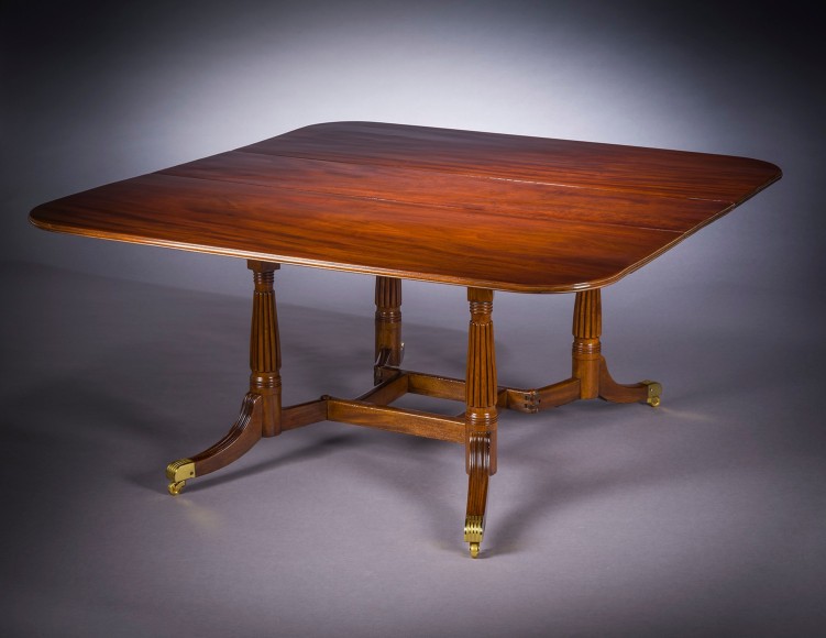 Cumberland-action Dining Table, about 1815–20. Attributed to Thomas Seymour, possibly for Isaac Vose, Boston. Mahogany, with gilt brass toe-caps and castors 28 3/4 in. high, 62 1/4 in. long, 60 in. wide; with leaves down, 17 in. wide, 62 1/4 in. long