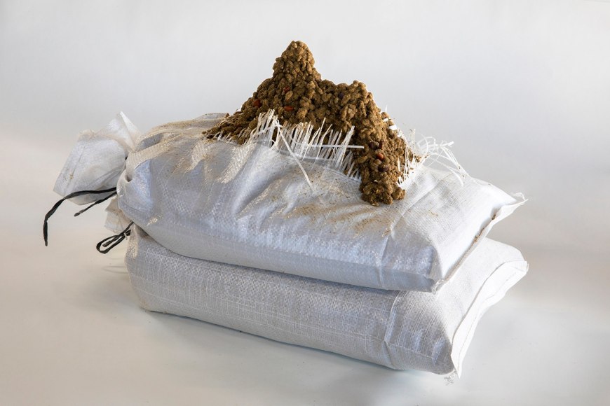 a sculpture by Lily Cox-Richard of a dribbled sand castle on two sand bags