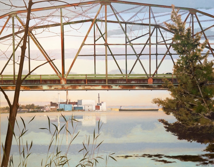 a rusting bridge over a river