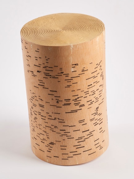 a sculpture by Maria Elena Gonzalez where a stump looks like a player piano roll and a record simultaneously