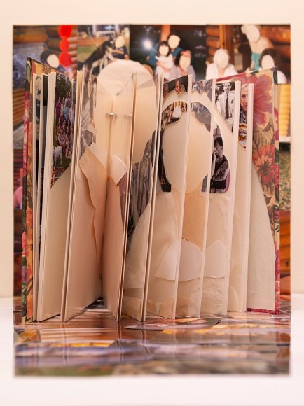photograph of a family album where pictures have been cutout to create a portrait of a couple