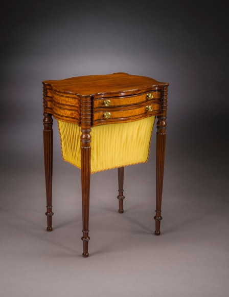 &quot;Work Table in the Sheraton Taste,&quot; about 1810 Attributed to Thomas Seymour, Boston. Mahogany, striped and bird&rsquo;s eye maple, and ebony, with gilt-brass drawer knobs, and fabric work bag 27 3/4 in. high, 19 1/4 in. wide, 15 3/4 in. deep