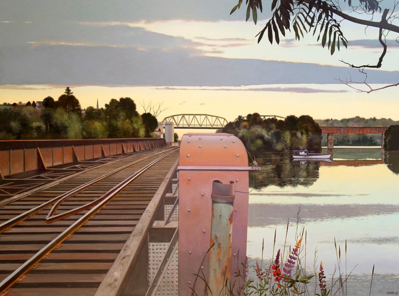 railroad tracks on a bridge over a river