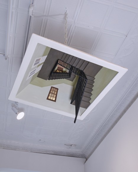 a sculpture of an overhead lamp with a descending stairwell hidden inside