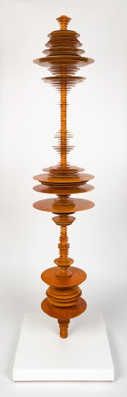 a sculpture by Elizabeth Turk of wood discs layered and arranged to resemble a sound wave and a modernist abstraction