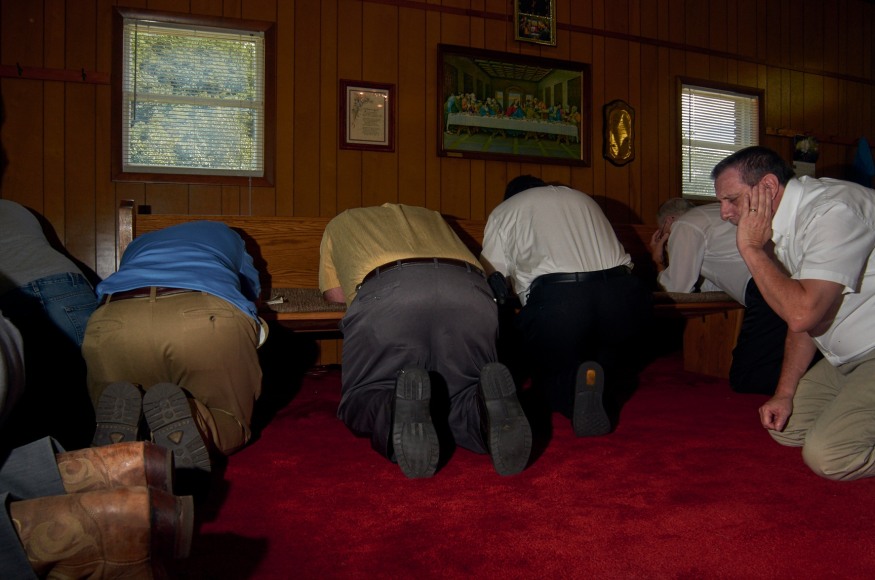 Stacy Kranitz  Garner, Kentucky, 2011  Archival Pigment Print  16 x 24 inches, Edition of 7  27 x 40 inches, Edition of 3, Five men kneeling in prayer, Kentucky