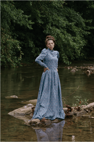 Stacy Kranitz  Stacy as Christy, 2012   Archival pigment print 16 x 24 inches, Edition of 7  27 x 40 inches, Edition of 3, Woman posing in period dress on a rock in a river.