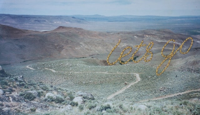 Lydia See  Let's Go, 2018  Embroidery on family photograph  4h x 7w in 10.16h x 17.78w cm  LS_008  $ 250.00, Landscape photograph of desert with Lets Go stitched on the surface