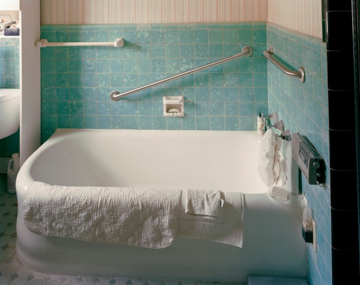 Photograph of bathtub in tiled bathroom, by Jade Doskow, by Jade Doskow