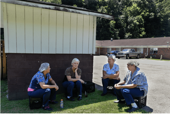 Stacy Kranitz  Elkhorn City, Kentucky, 2016, 2016  Archival Pigment Print  16 x 24 inches, Edition of 7  27 x 40 inches, Edition of 3, Women workers sitting in a circle, Kentucky