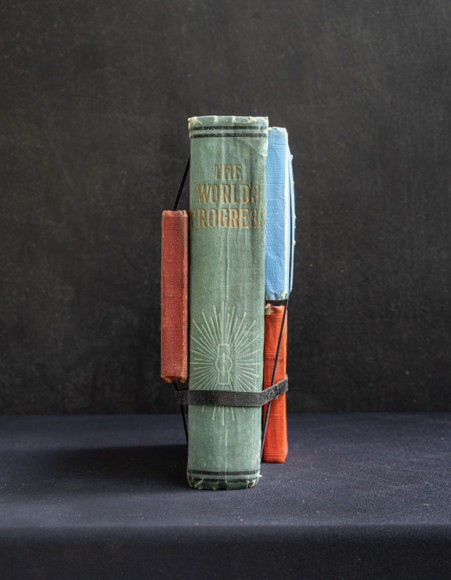 James Henkel  Progress From the Series Books, 2020  20h x 16w in 50.80h x 40.64w cm  Edition 5  JHe_060 3 hand sized books strapped onto a book that appears to be roughly 400 pages long