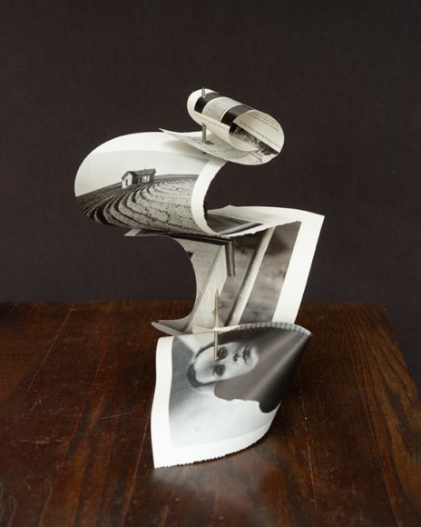 Photograph of other cut photographs pierced and bent on a spindle.