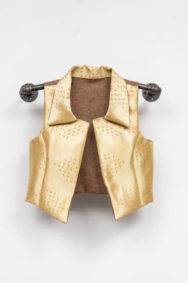 Yellow Kevlar vest. This vest is tailor-made to fit and protect Aaliyah, one of my three interns during a 2018 residency at&nbsp;Platte Forum&nbsp;in Denver. Unsettled by persistent gun violence in this country, Aaliyah, an outspoken yet sensitive person, expressed constant fear of facing armed shooters at high school. Her vest fabric was&nbsp;laser-engraved at UNCA STEAM Studio&nbsp;with a pattern comprised of Run/Hide/Fight active shooter instructions.