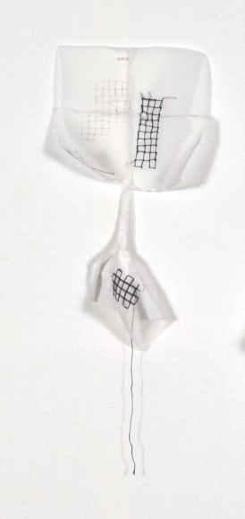 Kathryn Clark  Wunderkammer 7, 2019  ink, machine and hand embroidery on cotton organdy  22h x 8w x 4d in -white cotton wall sculpture with stitching and words written in ink