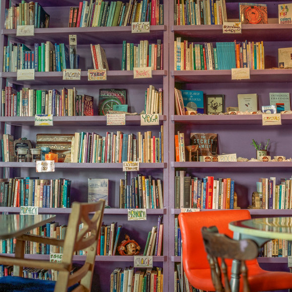 Ken Abbott  Bookstore and Cafe, Haywood Road, West Asheville, November 2003, Printed 2020  Archival Pigment Print  Image Size: 7 x 7 in Paper size 12 x 9 1/2 in Mat Size: 14 x 11 in  Edition of 10  $ 300.00 unframed, Photograph of the interior of a new age bookstore