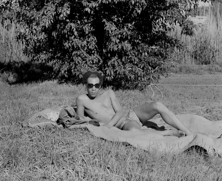 Man laying in park on blanket. Photograph by Mike Smith