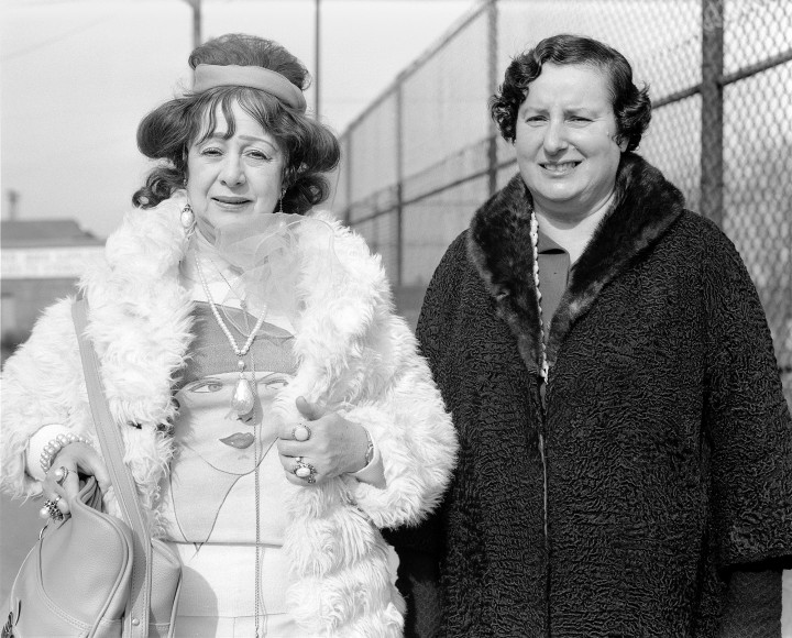 Two women in fancy coats. Photograph by Mike Smith
