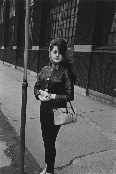 Woman outside a tire factory waiting for a bus , 1968
