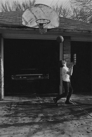 Boy playing basketball , 1968